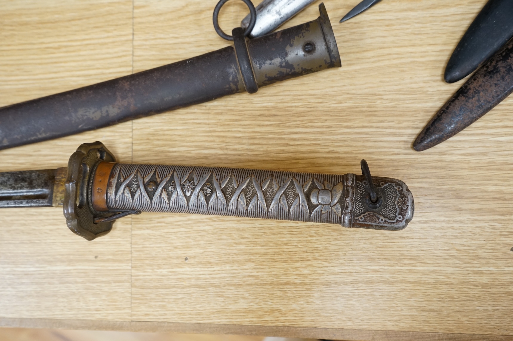 A Japanese World War II NCO‘s sword katana, regulation blade with fuller, stamped 33271, regulation aluminium hilt, brass guard, the spring catch still retains, in an iron scabbard